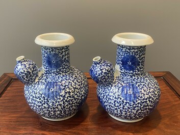 A pair of Chinese blue and white 'lotus scroll' kendis, 19th C.