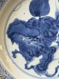 A pair of Chinese blue and white 'Buddhist lion' plates, ding mark, Kangxi