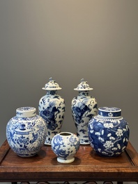 A pair of Chinese blue and white covered vases and three jars, 19th C.