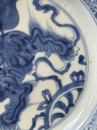 A pair of Chinese blue and white 'Buddhist lion' plates, ding mark, Kangxi