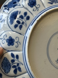 A pair of Chinese blue and white 'Mongolian hunting scene' plates and a pair of plates with floral design, Chenghua and Kangxi mark, Kangxi