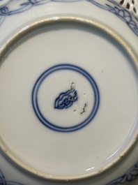 A Chinese blue and white reticulated double-walled cup and saucer, Kangxi