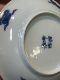 Four Chinese blue and white saucers and an 'erotic' cup, Kangxi