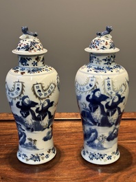 A pair of Chinese blue, white and copper-red vases and covers, Kangxi mark, 19th C.