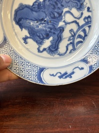 A pair of Chinese blue and white 'Buddhist lion' plates, ding mark, Kangxi