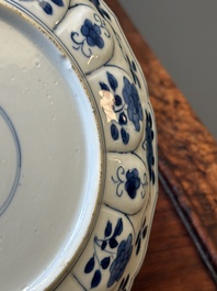 A pair of Chinese blue and white 'Mongolian hunting scene' plates and a pair of plates with floral design, Chenghua and Kangxi mark, Kangxi