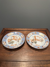 A pair of Chinese Imari-style plates with a merchant, lady and boy, Yongzheng