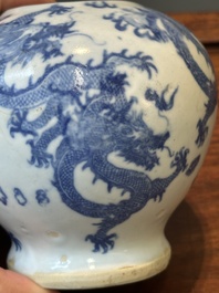 A pair of Chinese blue and white covered vases and three jars, 19th C.