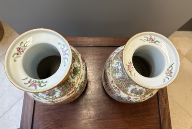 A pair of Chinese Canton famille rose vases with wooden stands, 19th C.