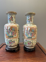 A pair of Chinese Canton famille rose vases with wooden stands, 19th C.