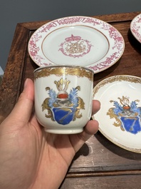 A pair of monogrammed Chinese puce-enamelled plates and a pair of armorial cups and saucers, Yongzheng/Qianlong