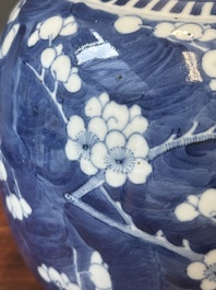 A pair of Chinese blue and white covered vases and three jars, 19th C.