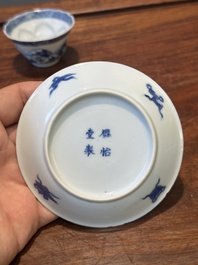 Four Chinese blue and white saucers and an 'erotic' cup, Kangxi