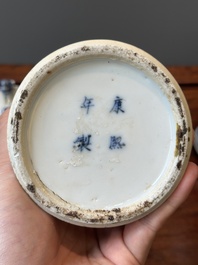 A pair of Chinese blue and white covered vases and three jars, 19th C.