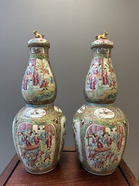 A pair of Chinese Canton famille rose double gourd vases and covers, 19th C.