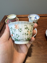 A pair of Chinese famille verte and a pair of famille rose cups and saucers, Kangxi/Yongzheng