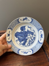 A pair of Chinese blue and white 'Buddhist lion' plates, ding mark, Kangxi