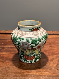 A small Chinese wucai 'Buddhist lion and peony scroll' jar, Transitional period