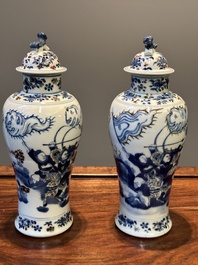 A pair of Chinese blue, white and copper-red vases and covers, Kangxi mark, 19th C.