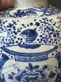 A pair of Chinese blue and white covered vases and three jars, 19th C.