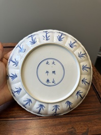 A pair of Chinese blue and white 'Mongolian hunting scene' plates and a pair of plates with floral design, Chenghua and Kangxi mark, Kangxi