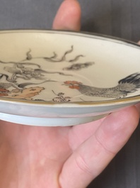 A pair of Chinese grisaille and iron-red 'buffalo' cups and saucers and a 'rooster' saucer, Yongzheng