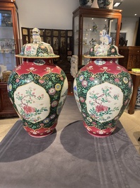 A pair of Chinese famille rose black-ground jars and covers with mountainous landscape design, Yongzheng