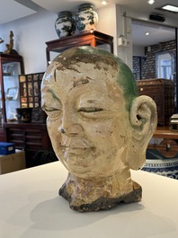 An imposing Chinese sancai glazed stoneware head of a monk, Yuan/Ming