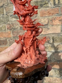 A Chinese red coral sculpture of Xiwangmu standing on a rock, 19/20th C.