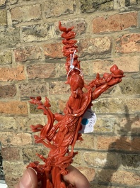 A Chinese red coral sculpture of Xiwangmu standing on a rock, 19/20th C.