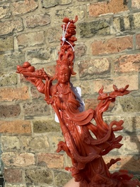 A Chinese red coral sculpture of Xiwangmu standing on a rock, 19/20th C.