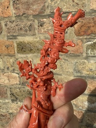 A Chinese red coral figure of a standing lady holding a vase, 19/20th C.