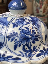 A Chinese blue and white garniture of three vases with floral and landscape design, Kangxi