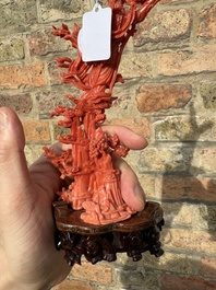 A Chinese red coral sculpture of Xiwangmu standing on a rock, 19/20th C.