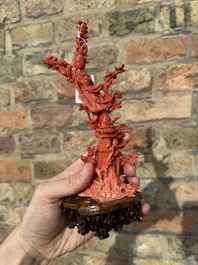 A Chinese red coral sculpture of Xiwangmu standing on a rock, 19/20th C.