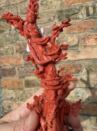 A Chinese red coral sculpture of Xiwangmu standing on a rock, 19/20th C.