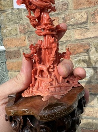 A Chinese red coral sculpture of Xiwangmu standing on a rock, 19/20th C.