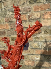 A Chinese red coral sculpture of Xiwangmu standing on a rock, 19/20th C.