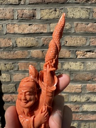 A Chinese red coral figure of a fisherman on wooden stand, 19/20th C.