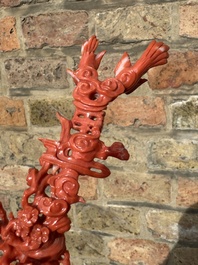 A Chinese red coral figure of a standing lady holding a vase, 19/20th C.