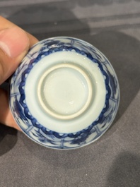 Thirteen Chinese blue and white saucers and twelve cups with figural design, Kangxi/Yongzheng