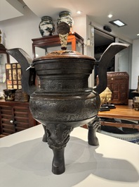 An important Chinese bronze tripod 'taotie' censer with wooden cover, Ming