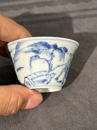 Thirteen Chinese blue and white saucers and twelve cups with figural design, Kangxi/Yongzheng