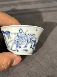 Thirteen Chinese blue and white saucers and twelve cups with figural design, Kangxi/Yongzheng