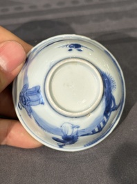 Thirteen Chinese blue and white saucers and twelve cups with figural design, Kangxi/Yongzheng