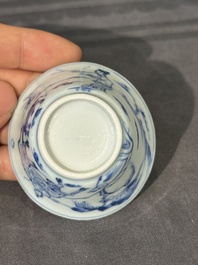 Thirteen Chinese blue and white saucers and twelve cups with figural design, Kangxi/Yongzheng