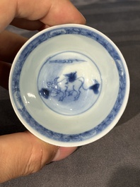 Thirteen Chinese blue and white saucers and twelve cups with figural design, Kangxi/Yongzheng