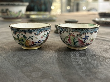 A pair of fine Chinese Canton enamel cups and three saucers with floral design, Yongzheng/Qianlong