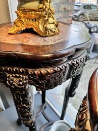 A pair of tall Chinese carved wooden stands with marble tops, 19th C.