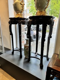 A pair of tall Chinese carved wooden stands with marble tops, 19th C.